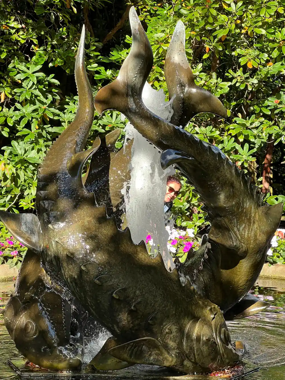 A bronze sculpture among leaves in a Victoria garden