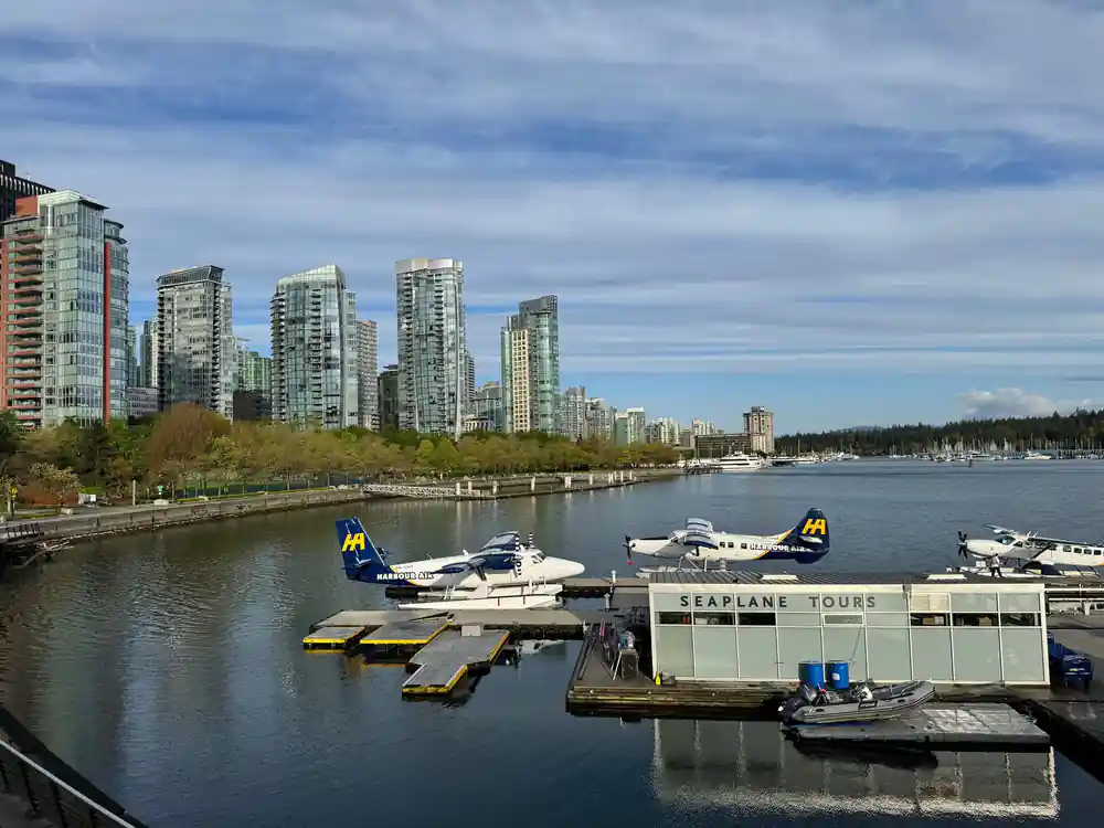Floatplanes at the Victoria dock beside a low terminal building