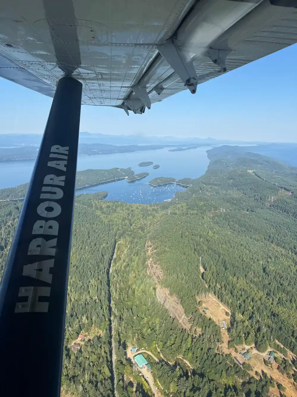 Islands and inlets far below, framed by the wing strut