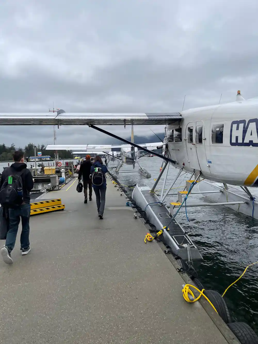 Passengers walking the dock towards the waiting aircraft