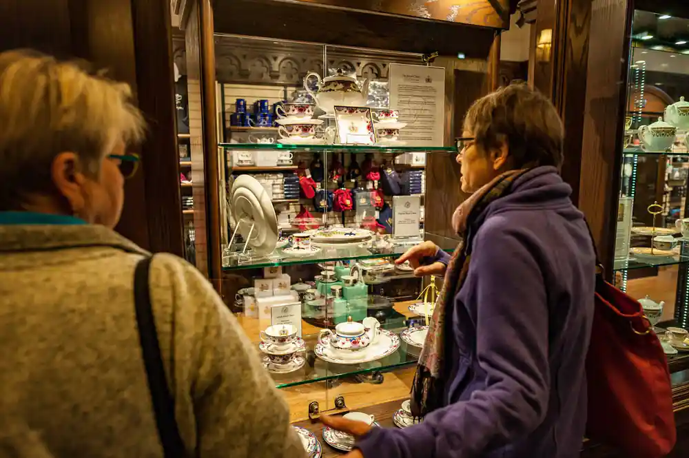 A shopper looking at china in a display cabinet