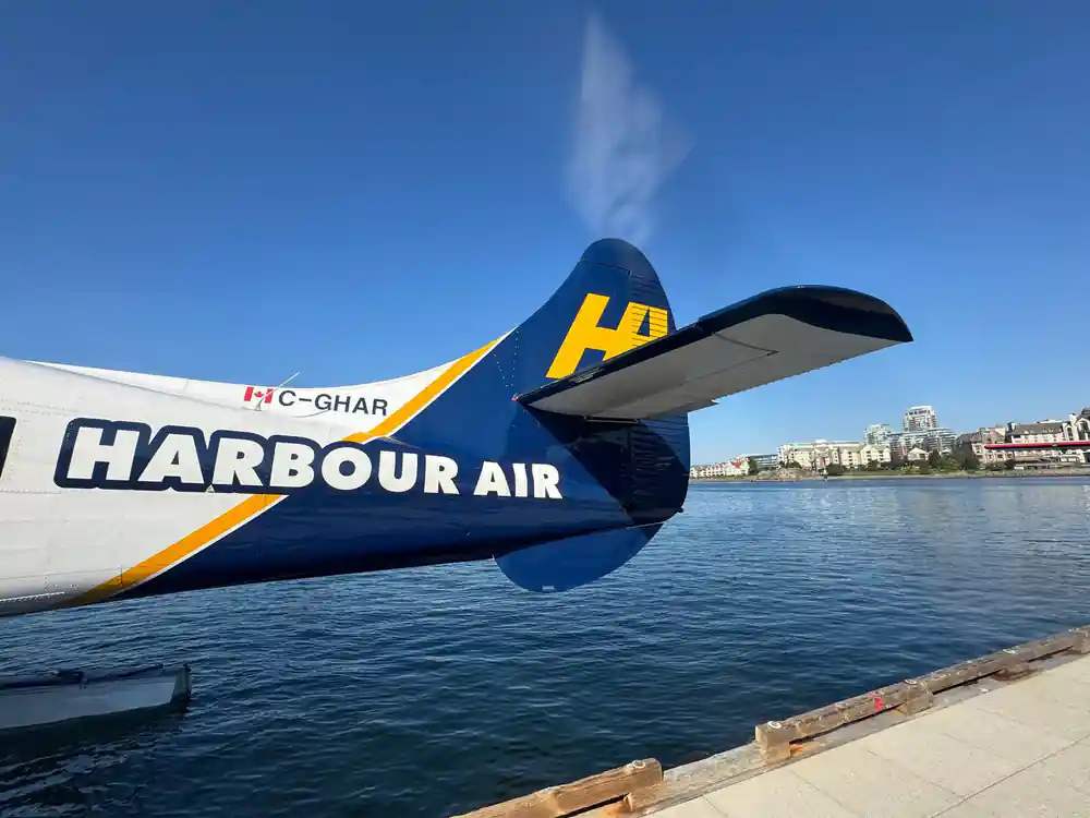 The tail of a Harbour Air aircraft against the sky at the dock